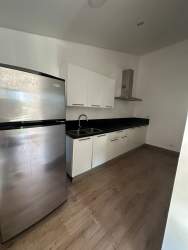 Large open-plan living dining room with marble floors and garden views in Nativa Panama Pacifico