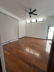 Modern kitchen with black granite island, white cabinetry and gas stove in PH Nativa rental home Panama