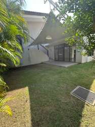 Spacious bedroom with wooden flooring, AC, walk-in closet, large window in Nativa Panama Pacifico rental home