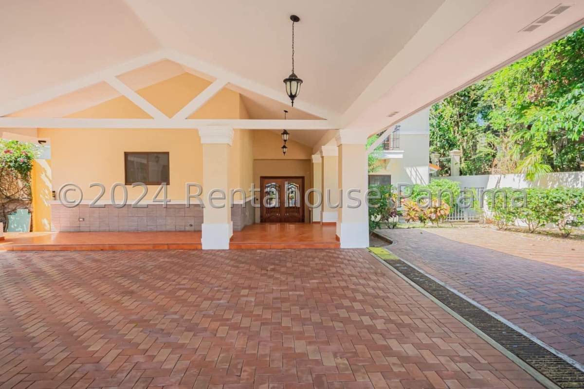 Elegant living room with double-height ceiling, tiled floors and chandelier in luxury Panama house