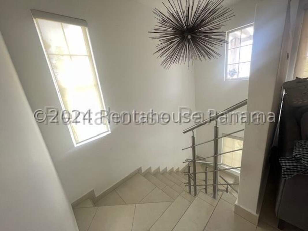 Modern equipped kitchen with white cabinetry appliances in Versalles Costa Sur Panama