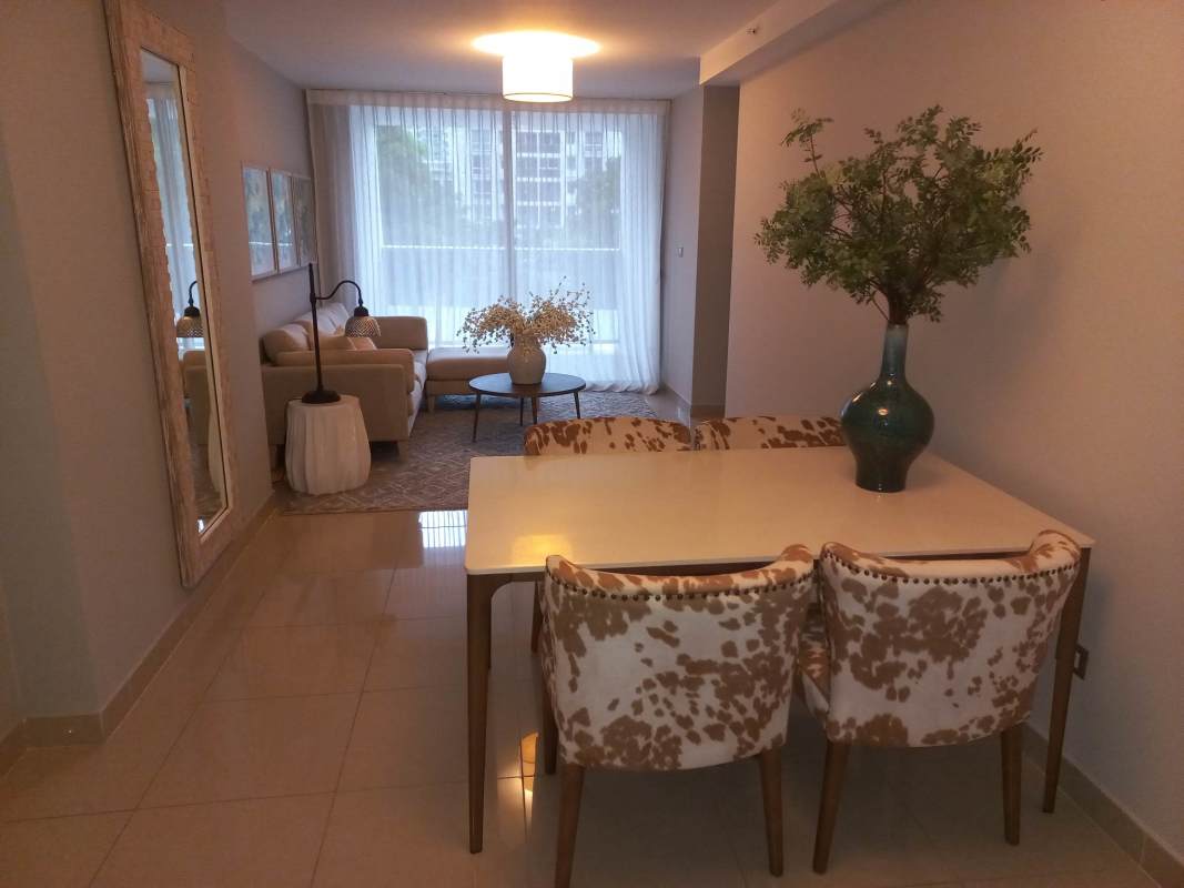 Living dining room with large window, neutral decor PH Villa de las Fuentes Panama