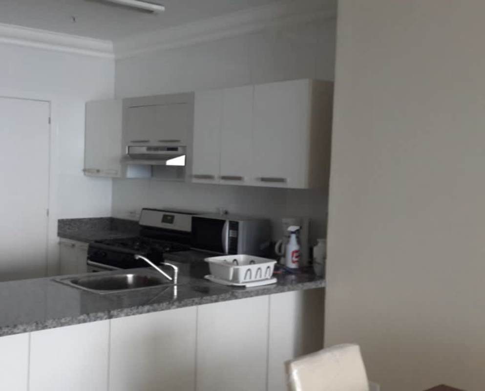 Kitchen with granite countertops and white cabinets in PH Waters on the Bay Avenida Balboa Panama