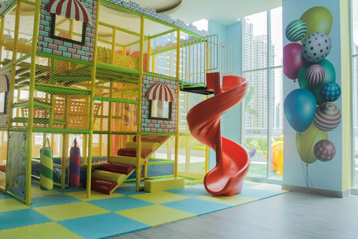 Bright children's indoor play area with spiral slide and soft flooring Ocean House Santa Maria