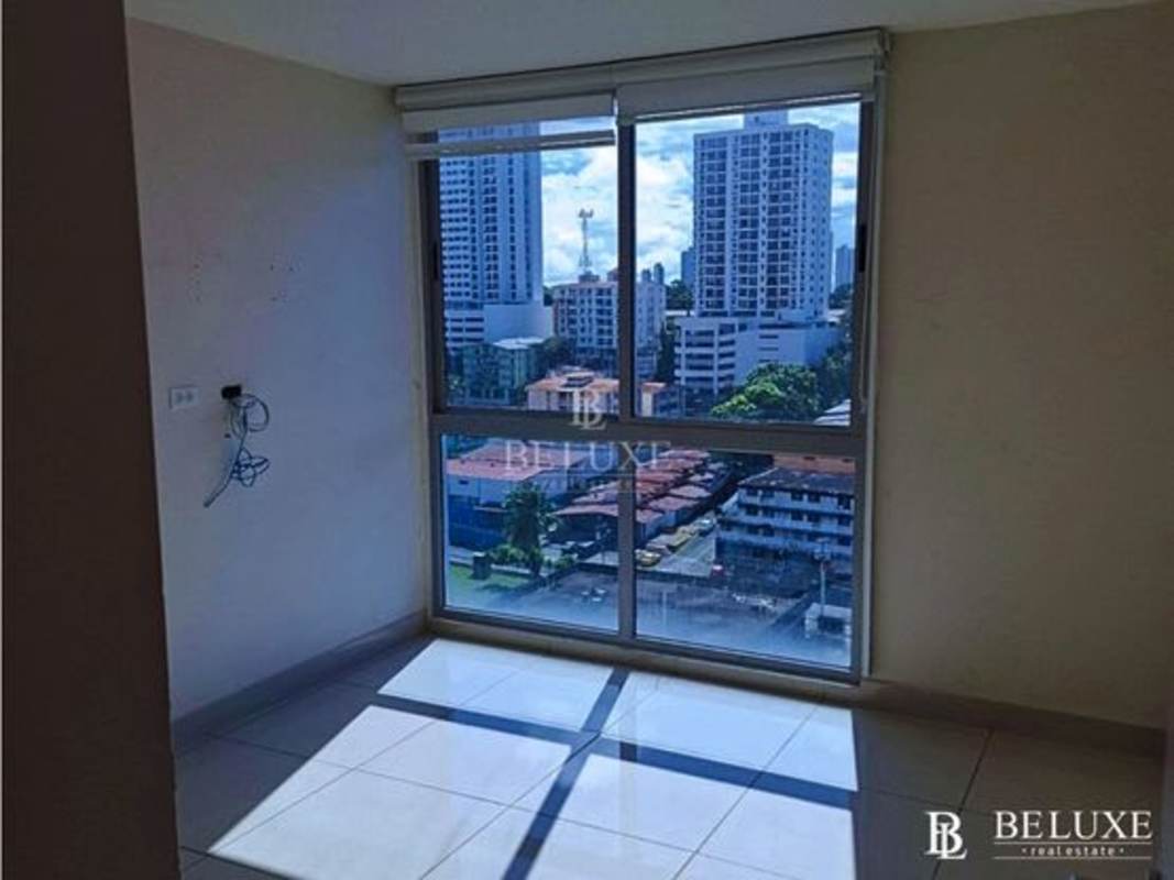 Bright empty interior room with large window city skyline view PH Torres de Castilla Panama City