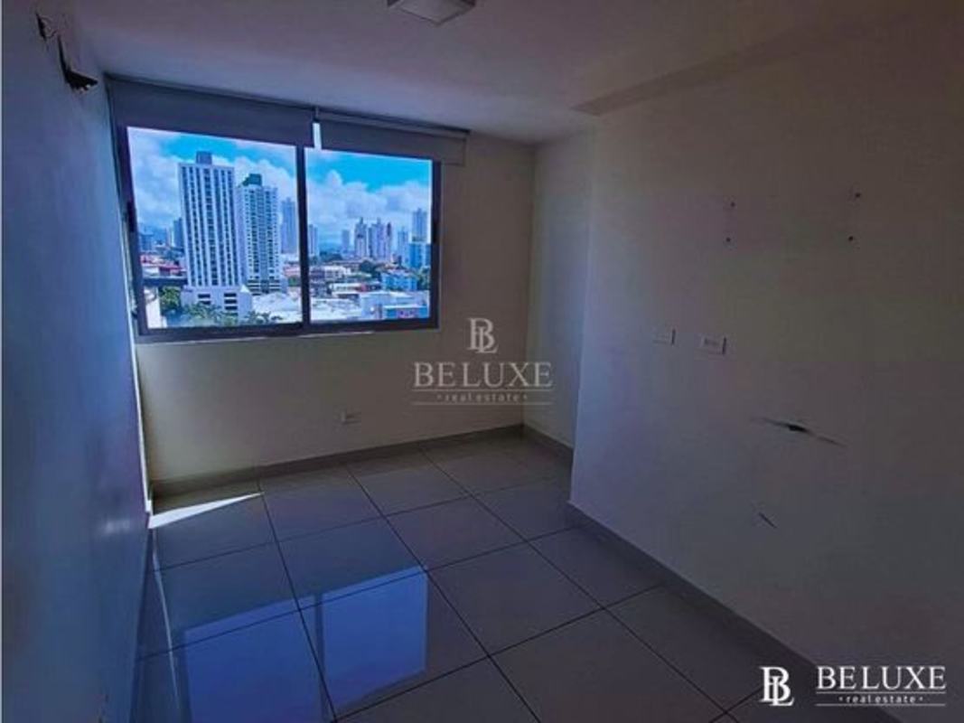 High-rise residential tower with glass facade and commercial plaza at PH Torres de Castilla Panama City