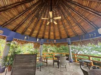 Covered terrace with palapa roof, ocean view, dining space luxury villa Punta Roca Panama