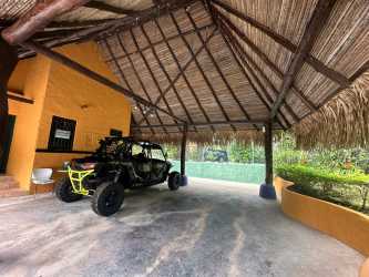 Rustic wooden gate with stone columns and tropical landscaping Punta Roca beachfront estate Panama