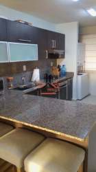 Open-plan living and contemporary kitchen with sofa and bar stools PH Marina Golf San Carlos Panama