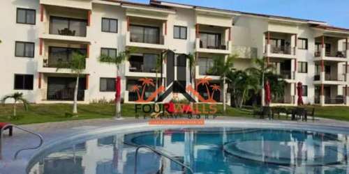 Swimming pool with sun decks, umbrellas surrounded by palm trees in PH Marina Golf San Carlos Panama