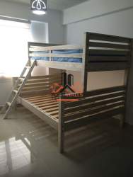 Minimalist bedroom featuring bunk beds and window view in PH Marina Golf San Carlos Panama