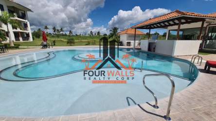 Outdoor pool with lounge chairs, tiled bar area at PH Marina Golf apartment complex Panama