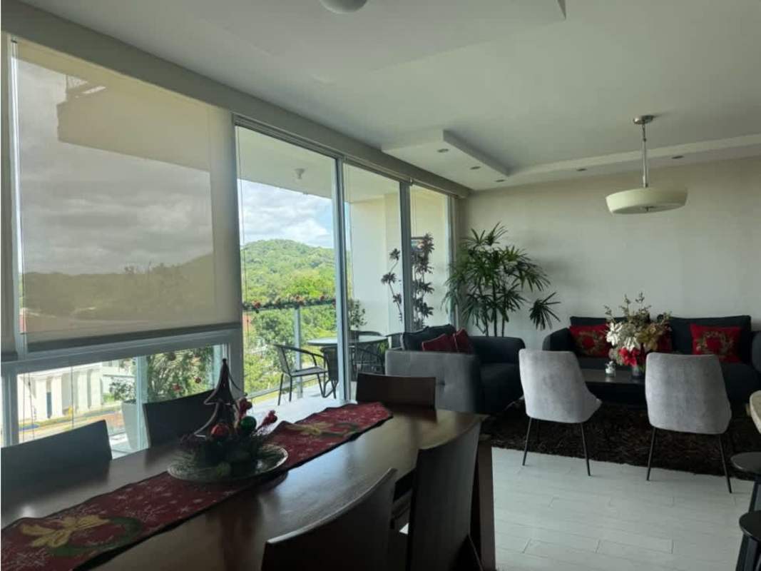 Balcony with round glass table, chairs, festive decoration, and mountain views PH Pine Hills Albrook Clayton apartment