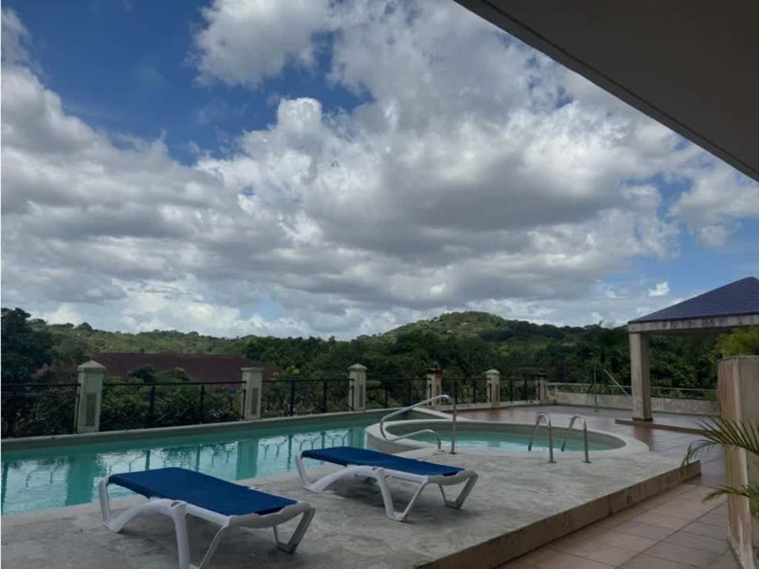 Outdoor pool with jacuzzi gazebo lounge chairs hill views PH Pine Hills Clayton apartment Panama sale