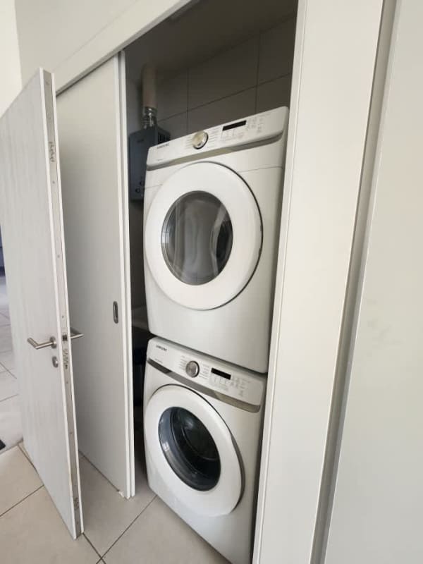 Compact laundry area with washer dryer hookups PH Coco Place apartment Panama City