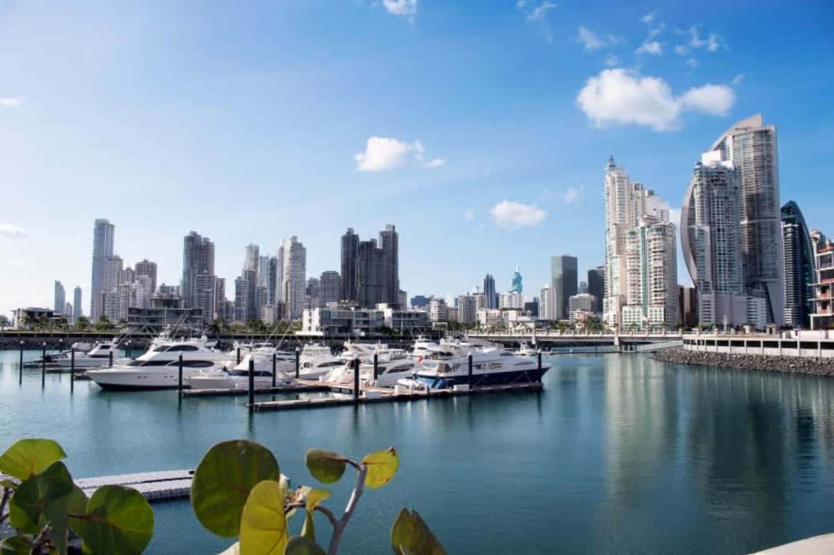 Modern skyscrapers overlook marina with boats docked at Ocean Reef Islands