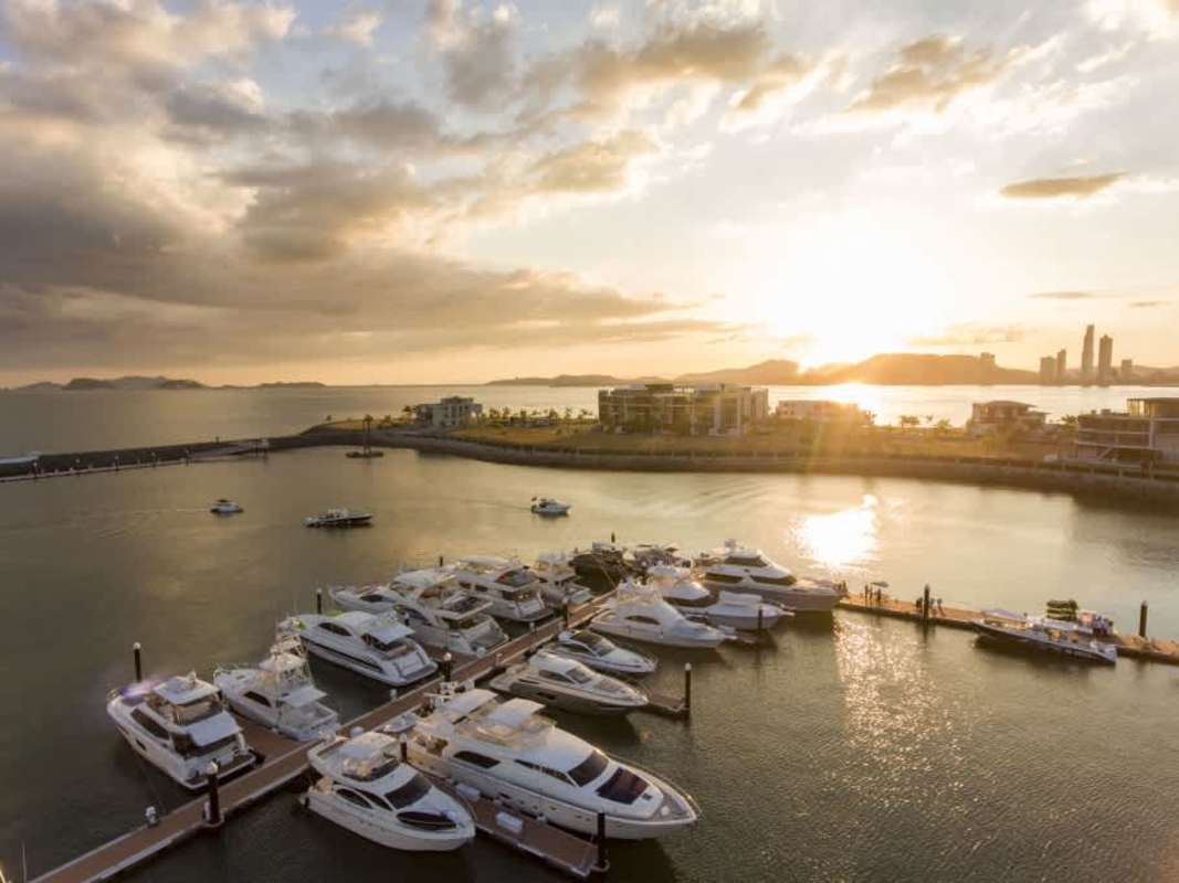Modern marina with yachts docked against a sunset sky on Ocean Reef Islands Panama City