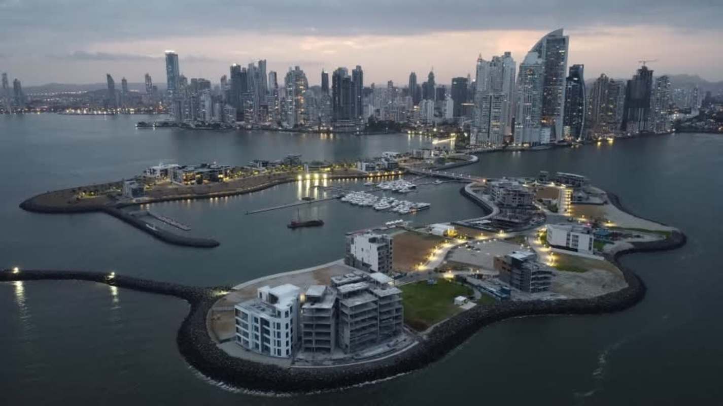 Aerial sunset panorama showing luxury artificial islands with marina and Panama City skyline