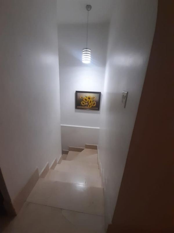 Large kitchen with granite countertops and wooden cabinets in Panama City house for sale