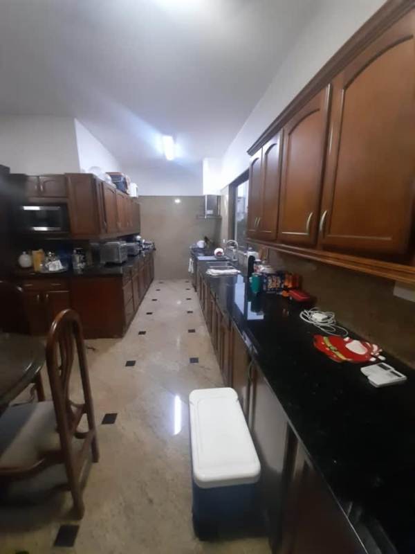 Bright open-plan living and dining room with marble floors in El Carmen Panama