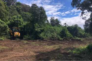 Bulldozer clearing lot on dense mountain land Volcancito Boquete Panama
