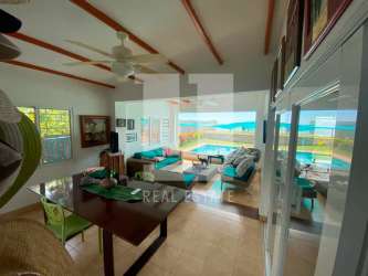 Dining room large windows ocean view beach house Playa El Palmar San Carlos Panama