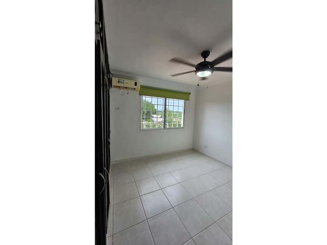 Spacious living area with large window, ceiling fan, tile flooring in Brisas del Golf Panama City
