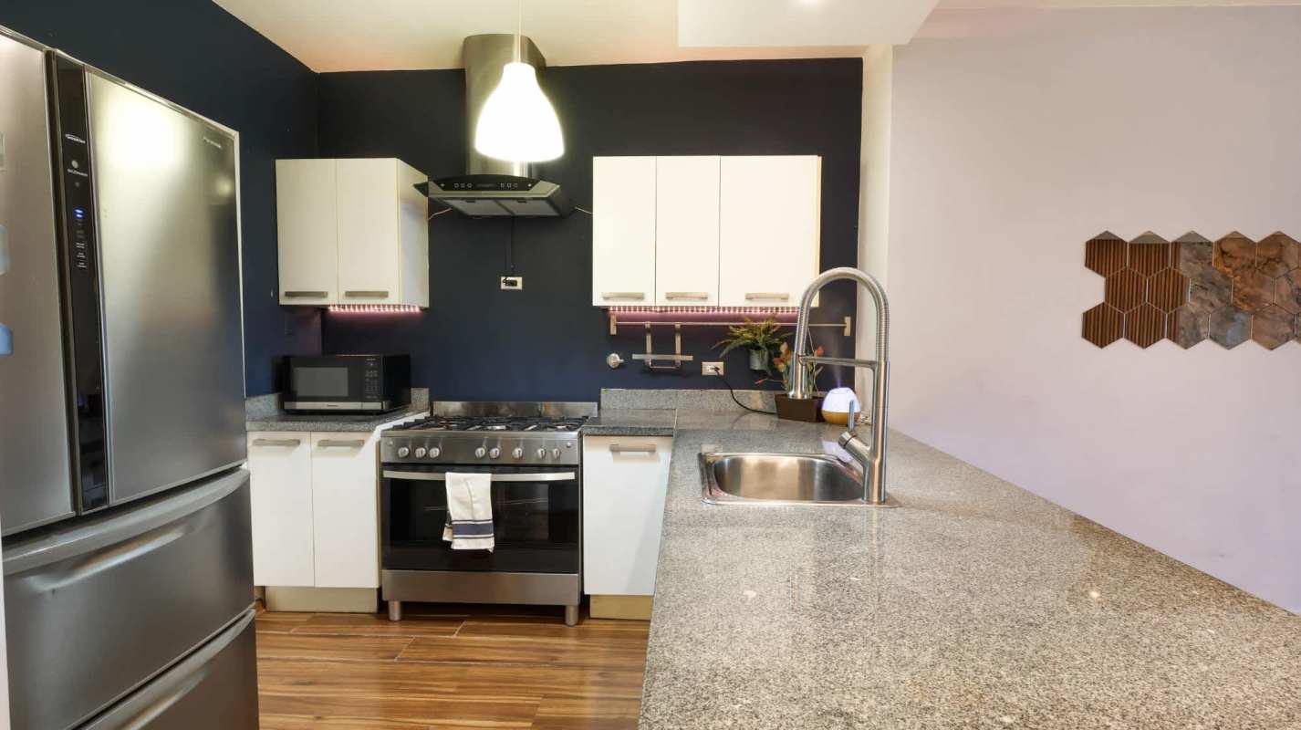 Open living area with floor-to-ceiling windows and ocean views PH Waters on the Bay Panama City