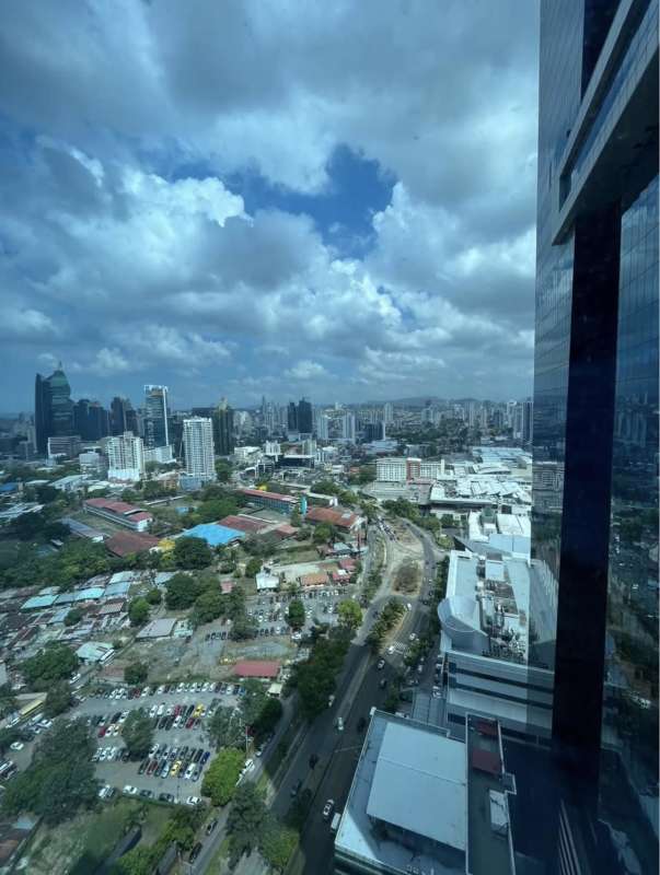 Office room with glass partitions, desks and chairs at Oceania Business Plaza Panama