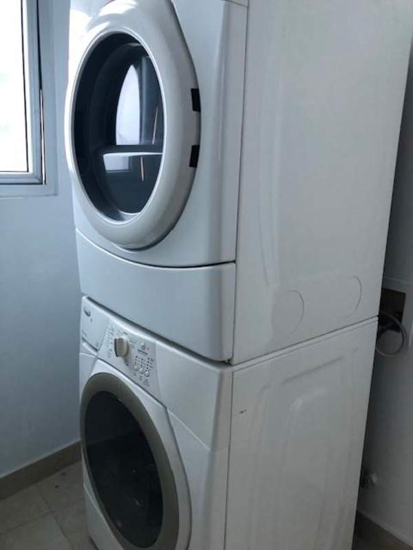 Large master bedroom with panoramic window and ocean skyline PH The Pearl Costa del Este Panama