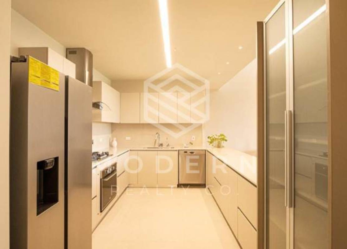 Luxury master bedroom with large windows overlooking golf course in Santa Maria Panama