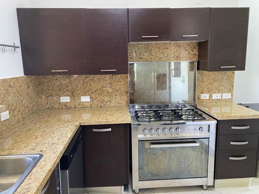 Fully equipped kitchen in Embassy Club Panama with granite counters, stainless appliances and garden view