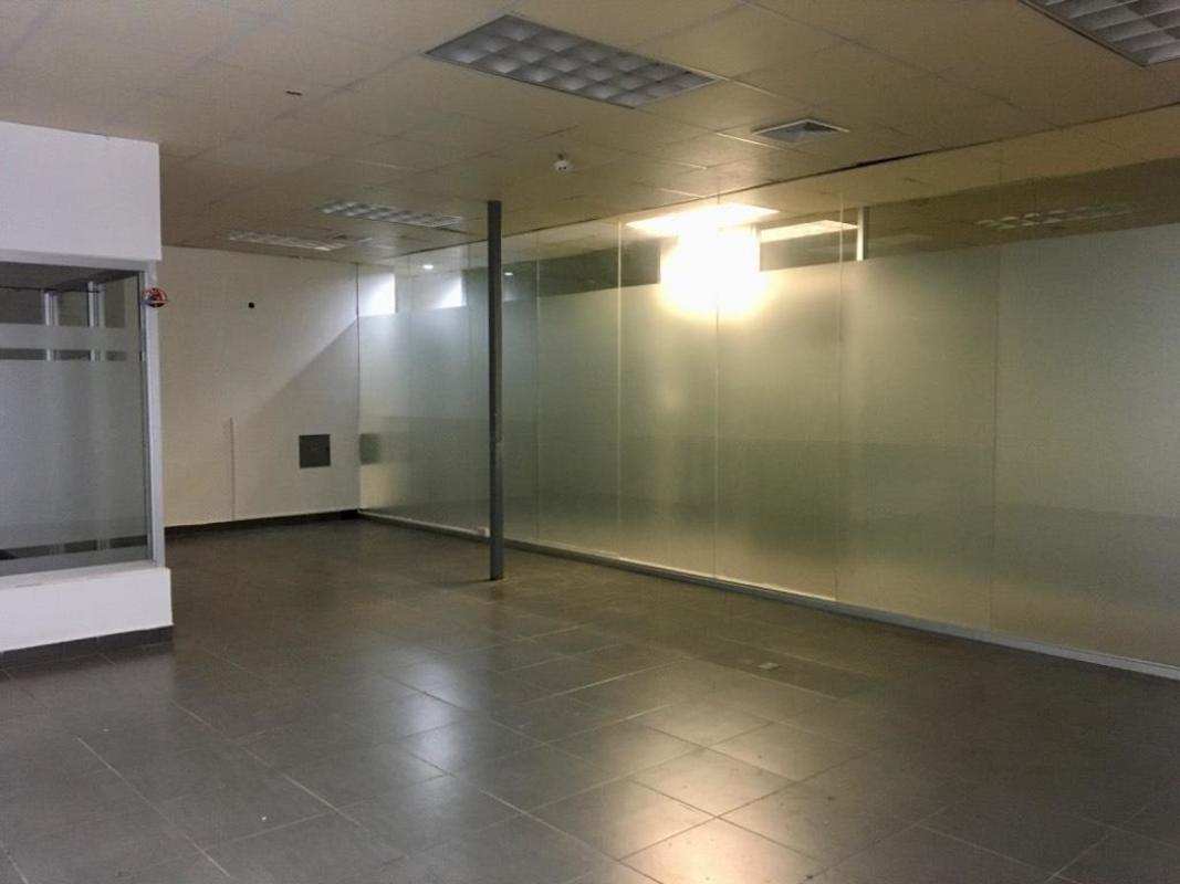 Empty office with frosted glass partitions and tiled flooring in Clayton commercial plaza Panama