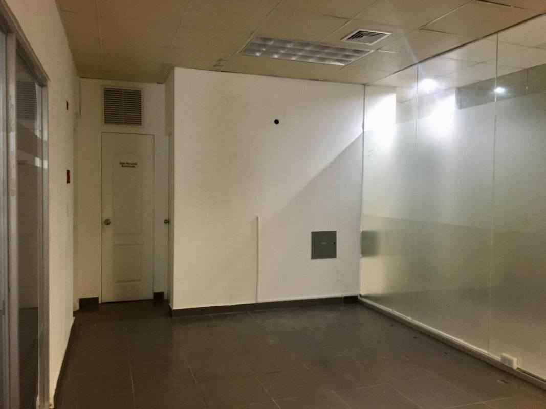 Modern commercial office with glass partitions and tile flooring in Plaza Clayton Panama