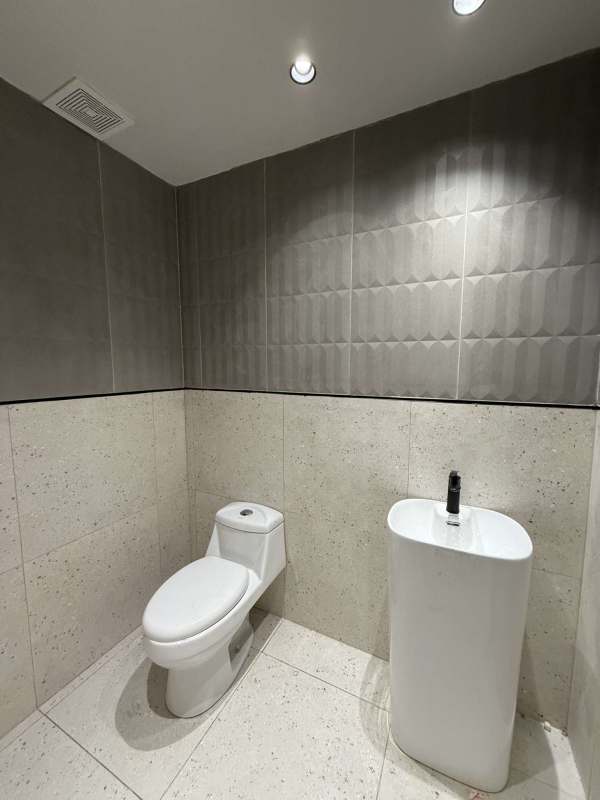 Modern office with floor-to-ceiling windows overlooking city and ocean at Costa del Este