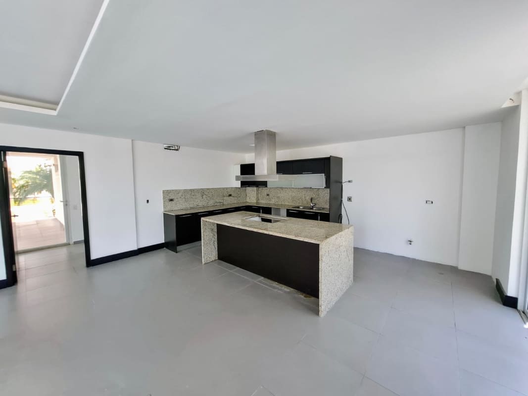 Gourmet open kitchen with granite island and stainless appliances in Costa Sur Panama home rental