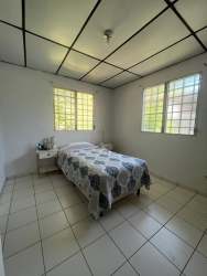 Minimalist bedroom featuring tiled floor, bright windows and ample natural light near Costa Verde