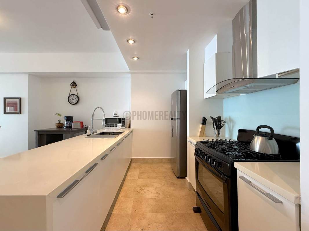 Balcony with glass railing overlooking Panama City skyline and Pacific Ocean, Yoo Panama luxury condo