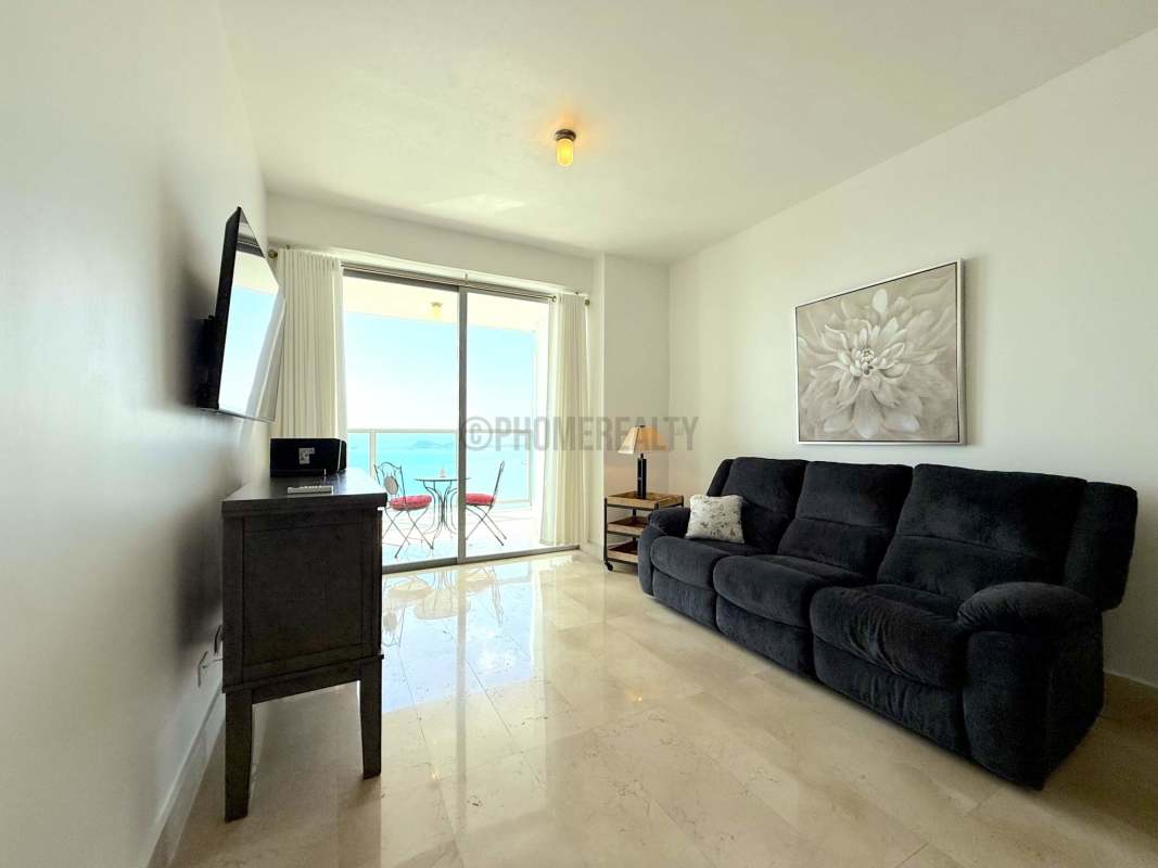 Modern living room with sliding glass doors, ocean view balcony at Yoo Panama on Avenida Balboa