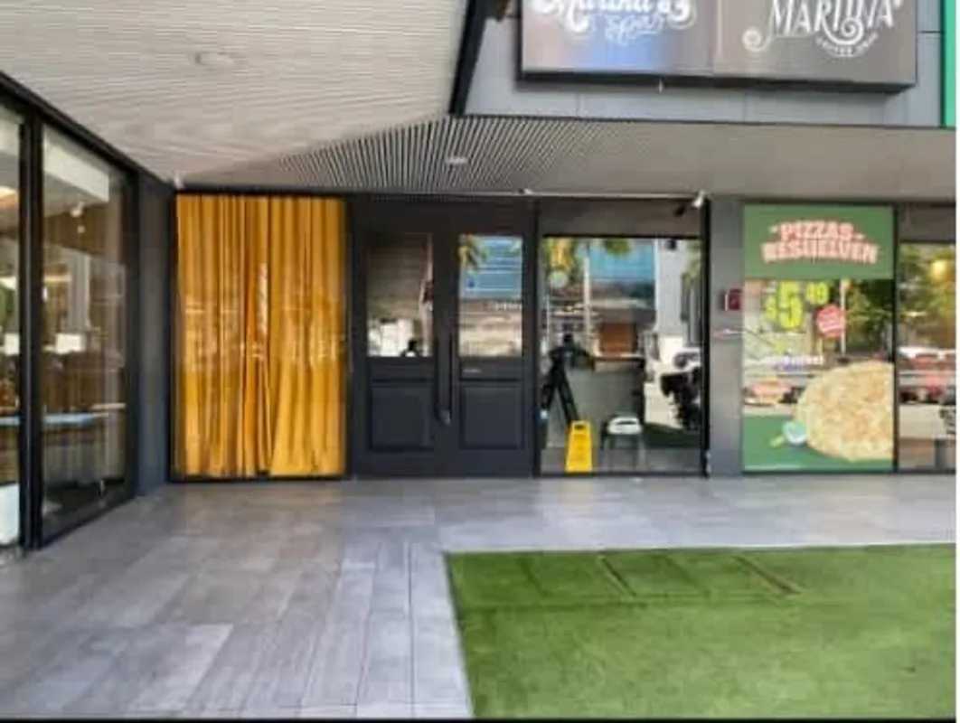 Street view with modern high-rise buildings, palm trees, cars at Costa del Este Panama City