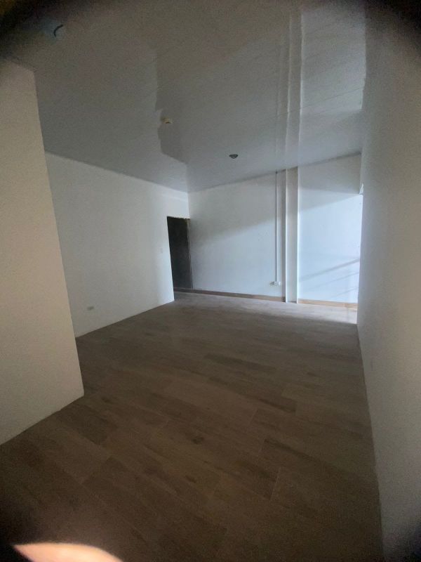 Double height retail unit interior with tile flooring and exposed concrete ceiling in Midtown Plaza