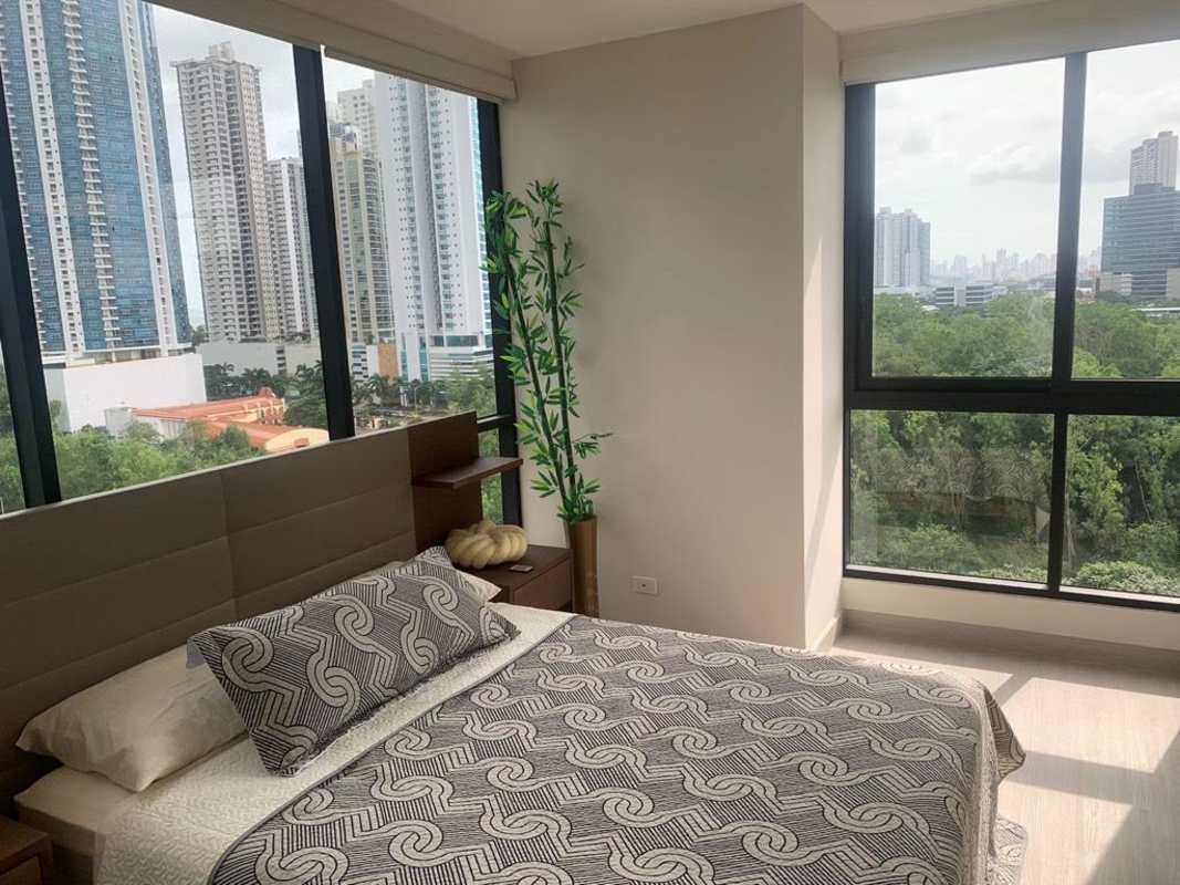 Master bedroom featuring walk-in closet, en-suite bath, and window views PH Arcadia Panama