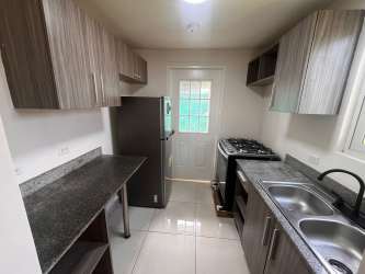 Contemporary bathroom with glass enclosed shower and porcelain tile in beach house for rent Panama