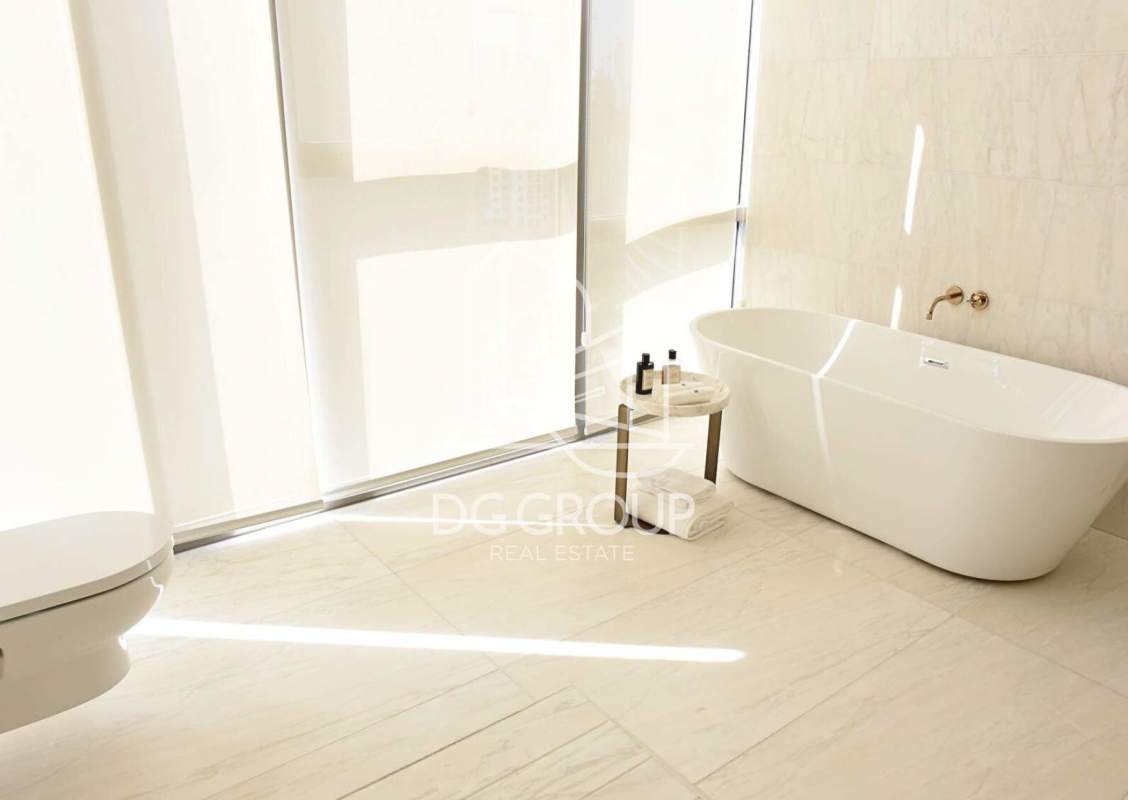 Modern marble bathroom with floor-to-ceiling window, city and ocean views in La Maison by Fendi Panama