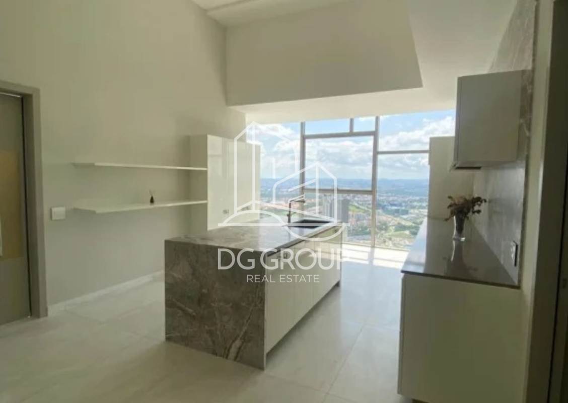 Luxury kitchen with marble island, panoramic windows, and city views in Santa María Panama