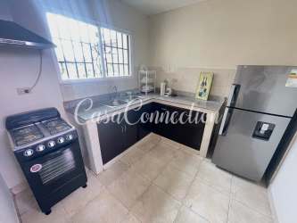 Kitchen corner with refrigerator, stove and cabinets in furnished house for rent David Panama