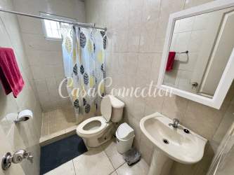 Modern bathroom with walk-in shower, tiled walls and sink in duplex rental David