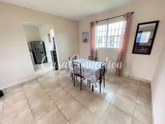 Bright dining room with window, garden view and access to kitchen in duplex rental David Panama