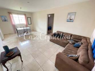 Dining room with window, tiled floor, neutral walls and table in duplex rental David Panama