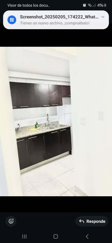 Modern kitchen with granite countertops and dark wood cabinets at PH Edison Park Panama
